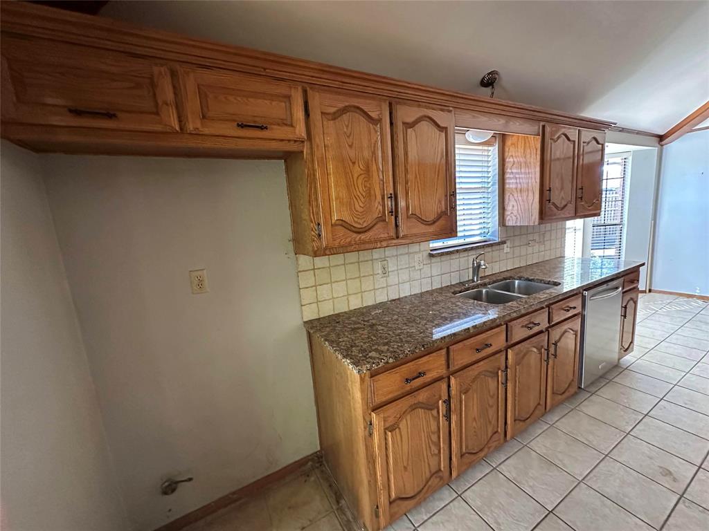 3713 Andrea Lane Rowlett, TX 75088 - Photo 4 of 18 a kitchen with stainless steel appliances granite countertop a sink stove and cabinets
