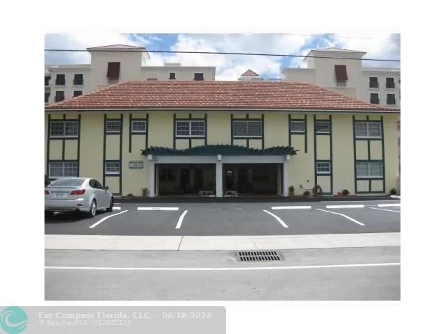 a front view of a residential apartment building with a yard