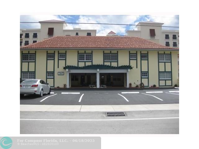 2404 Northeast 33rd Avenue, Unit 12 Fort Lauderdale, FL 33305 - Photo 1 of 13 a front view of a residential apartment building with a yard