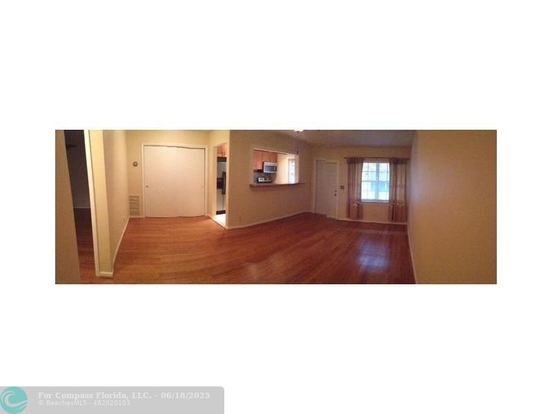 2404 Northeast 33rd Avenue, Unit 12 Fort Lauderdale, FL 33305 - Photo 2 of 13 a view of an empty room with kitchen and a window