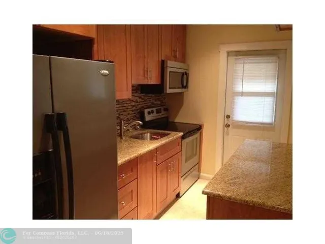 a kitchen with stainless steel appliances a refrigerator and a stove