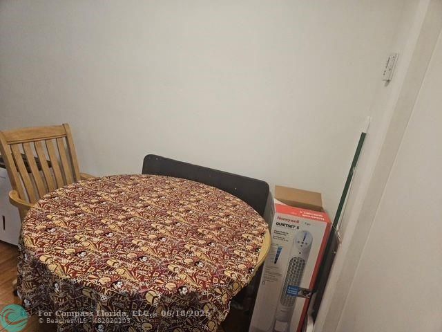 2404 Northeast 33rd Avenue, Unit 12 Fort Lauderdale, FL 33305 - Photo 7 of 13 a bedroom with a bed and wooden floor