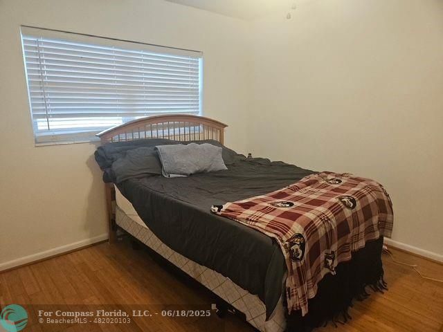 2404 Northeast 33rd Avenue, Unit 12 Fort Lauderdale, FL 33305 - Photo 8 of 13 a bedroom with a bed and a window