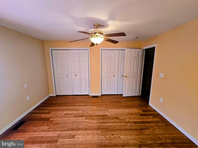 a spacious bathroom with a toilet a sink and mirror