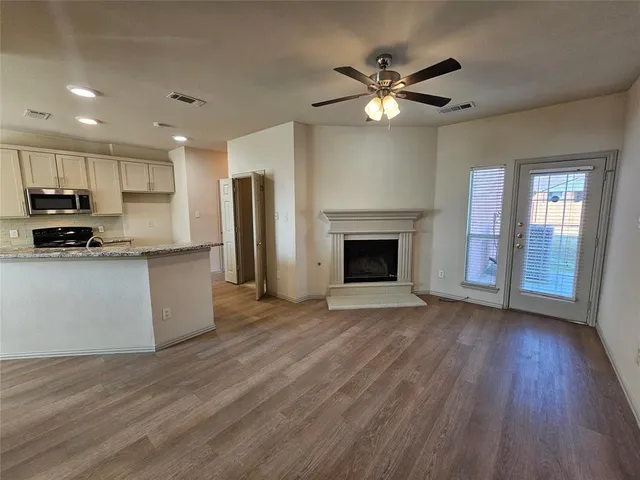 a view of kitchen with sink and wooden floor