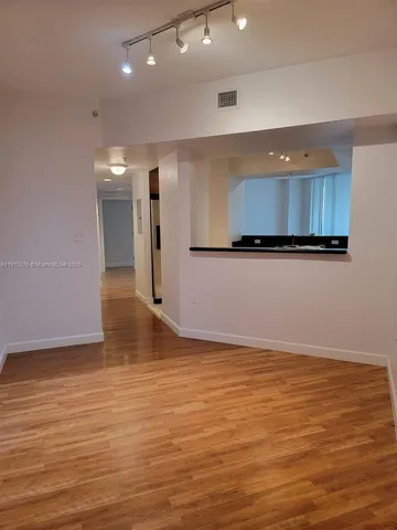 a view of a kitchen with wooden floor