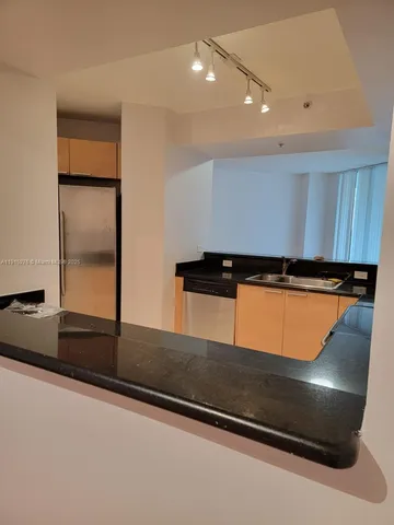 a kitchen with granite countertop a stove and a microwave