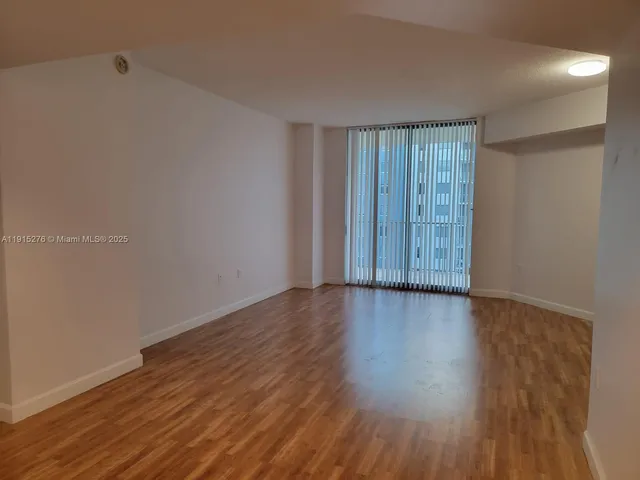 a view of wooden floor and brick walls