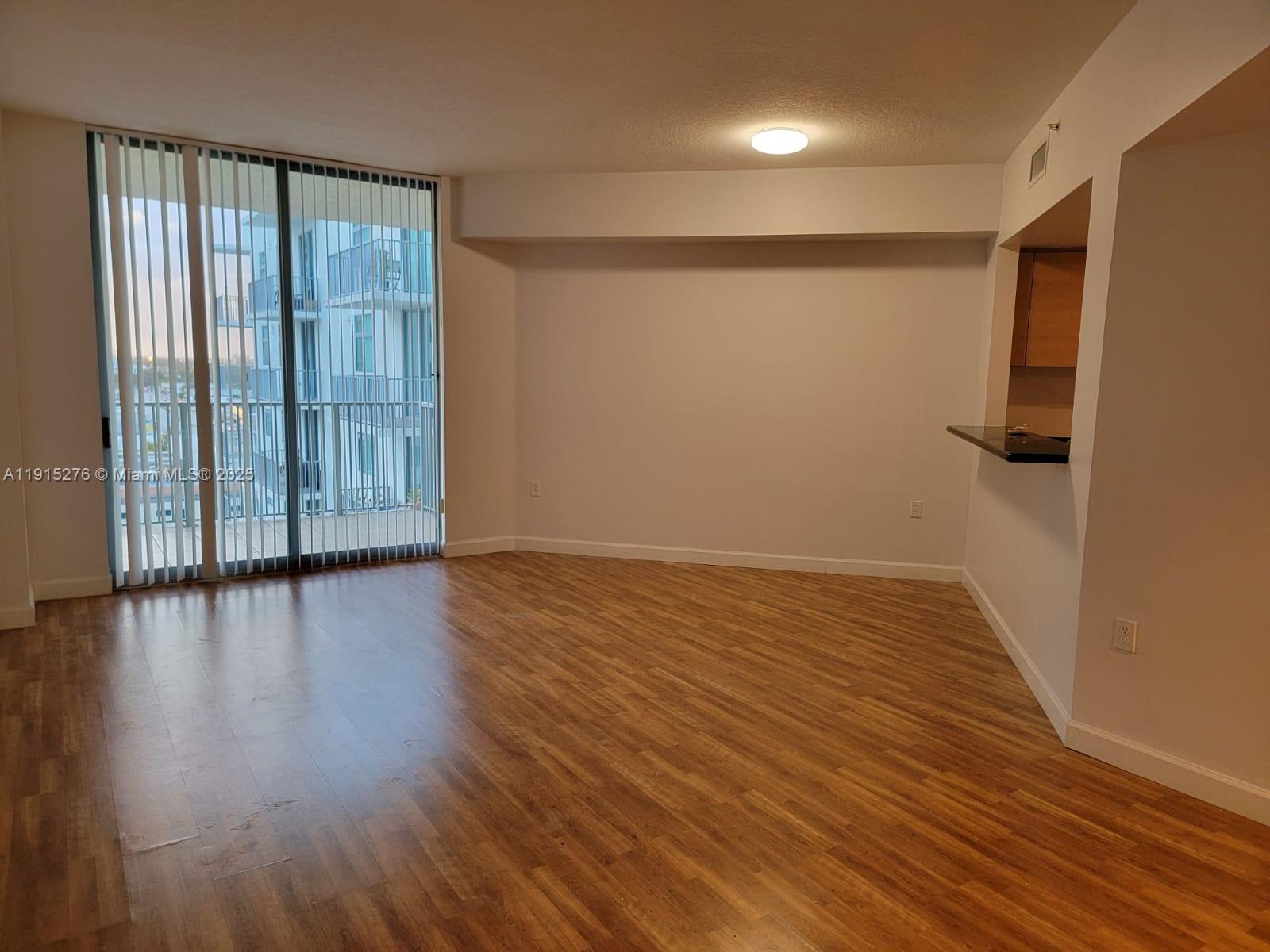 140 South Dixie Highway, Unit 908 Hollywood, FL 33020 - Photo 24 of 28 an empty room with wooden floor and windows