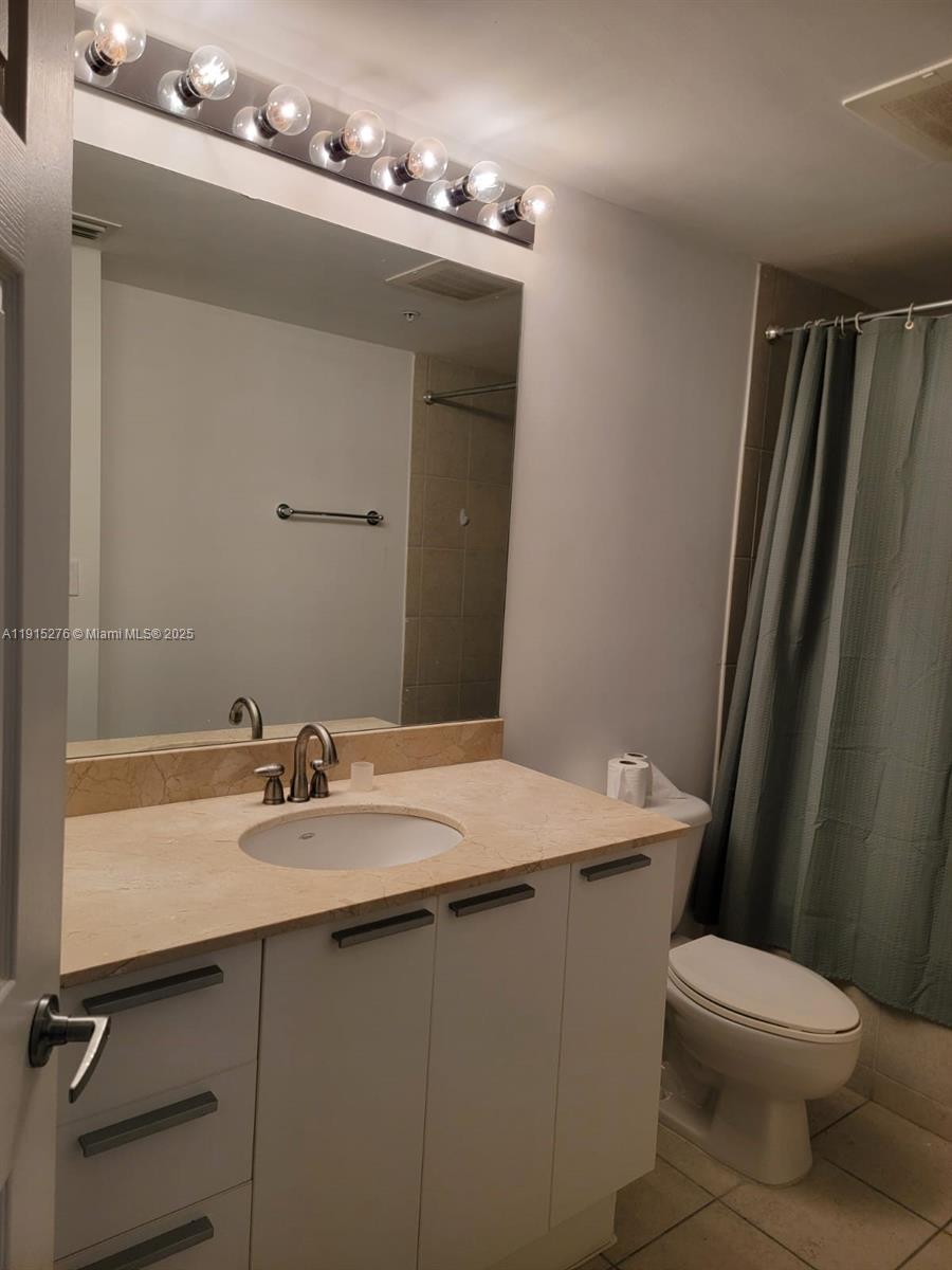 140 South Dixie Highway, Unit 908 Hollywood, FL 33020 - Photo 27 of 28 a bathroom with a sink a toilet and mirror