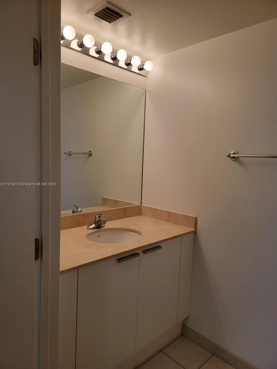 140 South Dixie Highway, Unit 908 Hollywood, FL 33020 - Photo 28 of 28 a bathroom with a granite countertop sink and a mirror