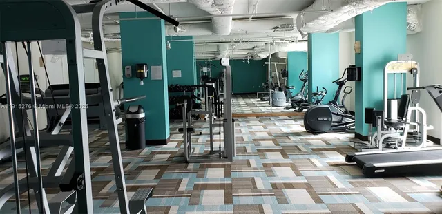 a view of a balcony with chairs and potted plants