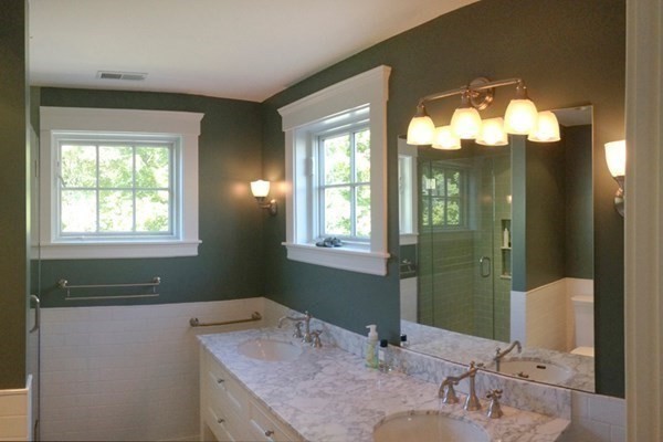 16 Anthony Road Bedford, MA 01730 - Photo 14 of 19 a bathroom with a granite countertop sink and a mirror