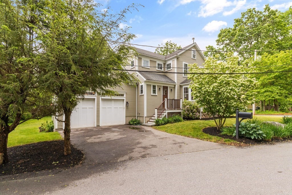 16 Anthony Road Bedford, MA 01730 - Photo 2 of 19 a view of a white house next to a yard with large trees