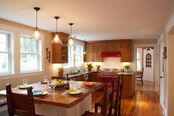 16 Anthony Road Bedford, MA 01730 - Photo 5 of 19 a view of a dining room and livingroom with furniture wooden floor a chandelier