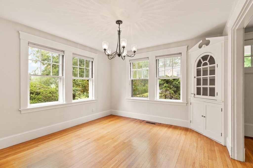 16 Anthony Road Bedford, MA 01730 - Photo 8 of 19 an empty room with wooden floor fan and windows