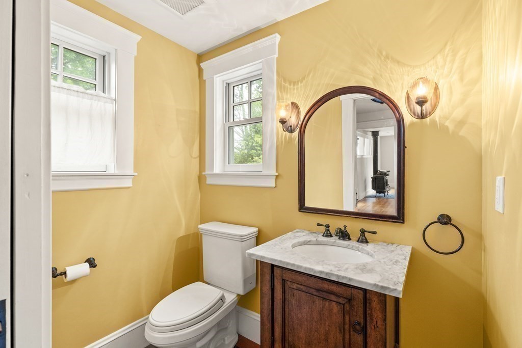 16 Anthony Road Bedford, MA 01730 - Photo 10 of 19 a bathroom with a granite countertop sink toilet and a mirror
