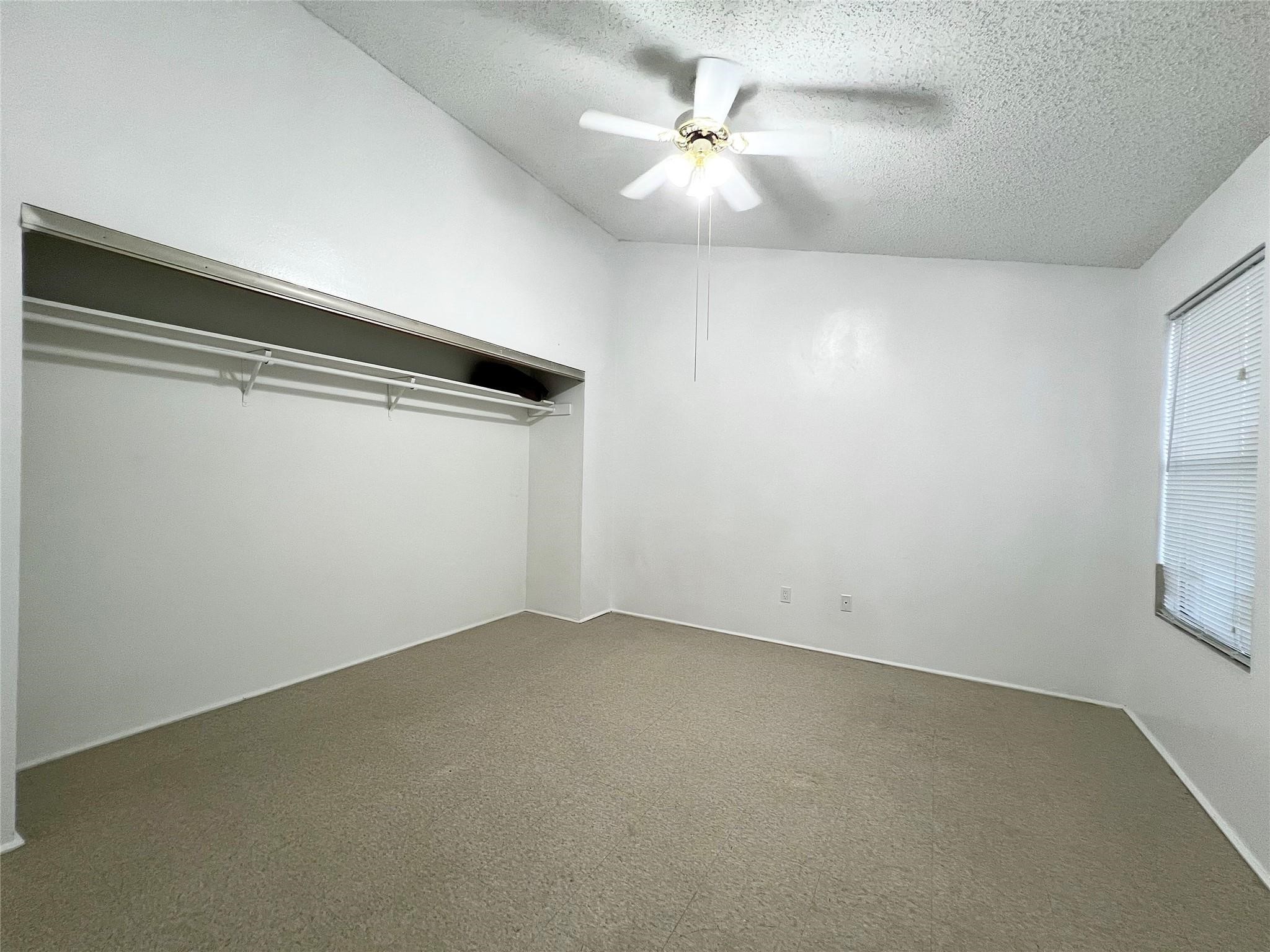 12710 Leader Street, Unit B Houston, TX 77072 - Photo 9 of 10 an empty room with a ceiling fan and window
