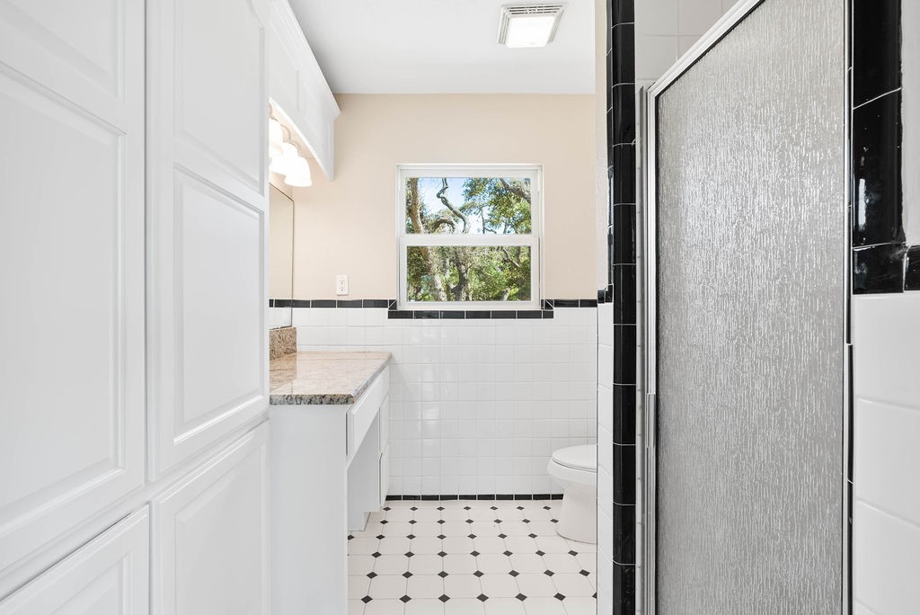 1931 North Fulton Beach Road Rockport, TX 78382 - Photo 17 of 40 a bathroom with a window a sink and a shower