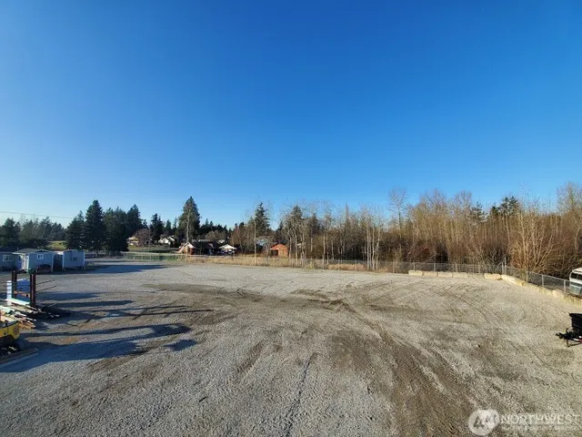 a view of dirt field with trees