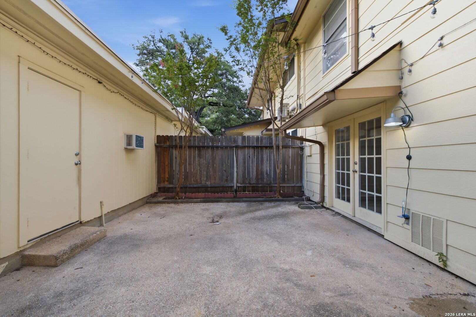 6106 Vance Jackson Road, Unit 15 San Antonio, TX 78230 - Photo 27 of 30 a view of a house with a small yard and wooden fence