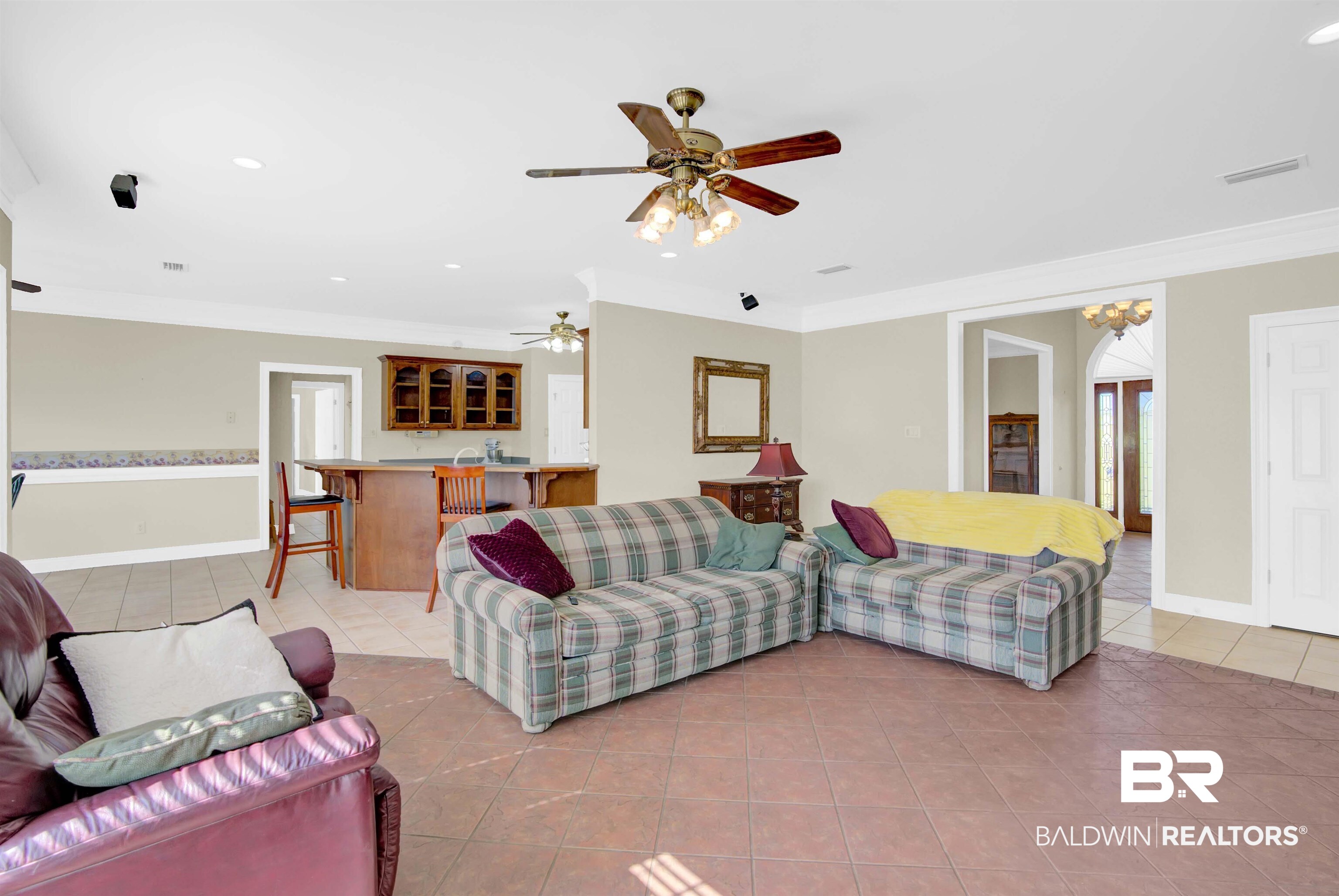 27688 Rigsby Road Daphne, AL 36526 - Photo 16 of 56 Living room with light tile patterned floors, crown molding, and ceiling fan