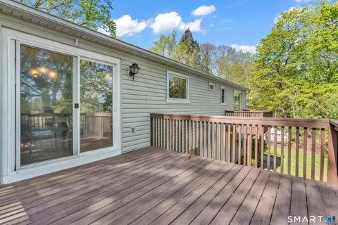 a view of backyard with a deck and wooden floor