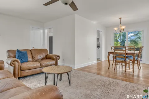 a living room with furniture and a dining table