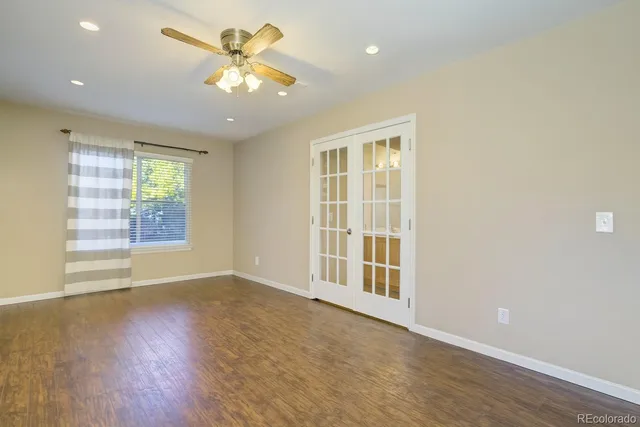 wooden floor in an empty room with a window