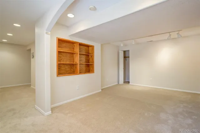 an empty room with windows and closet