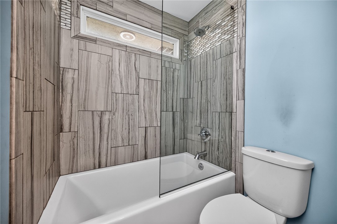 4747 Fawnwood Road Dayton, OH 45429 - Photo 41 of 58 Modern bath with wood-look tile and sleek fixtures offers a refreshing retreat.