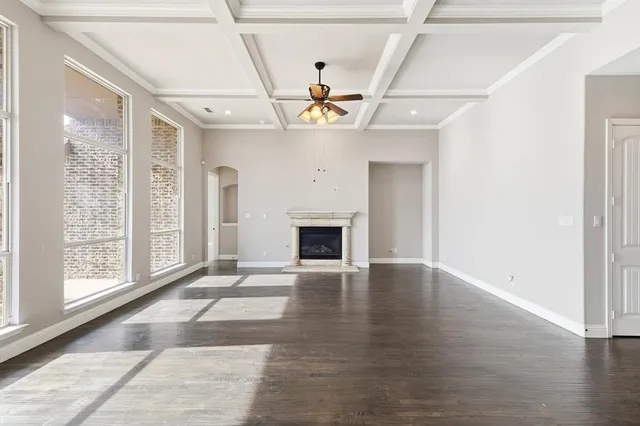 a view of an empty room with a window and fireplace