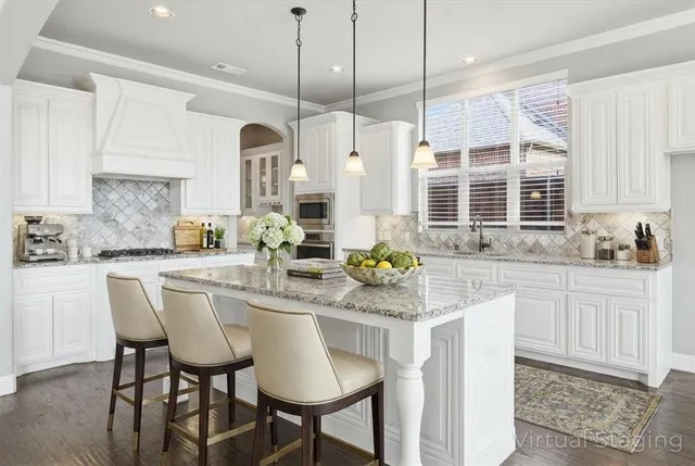 a kitchen with stainless steel appliances granite countertop a table chairs and a wooden cabinets