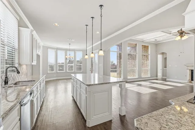 a view of a bathroom with a tub wooden floor and windows