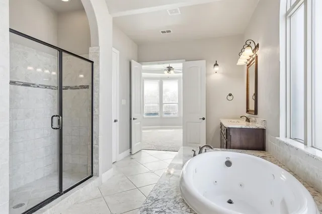 a bathroom with a tub and shower