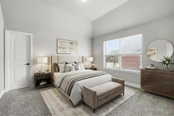 a bedroom with a bed and a dresser