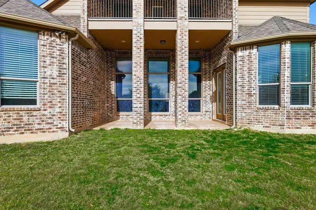 a view of a brick house with many windows