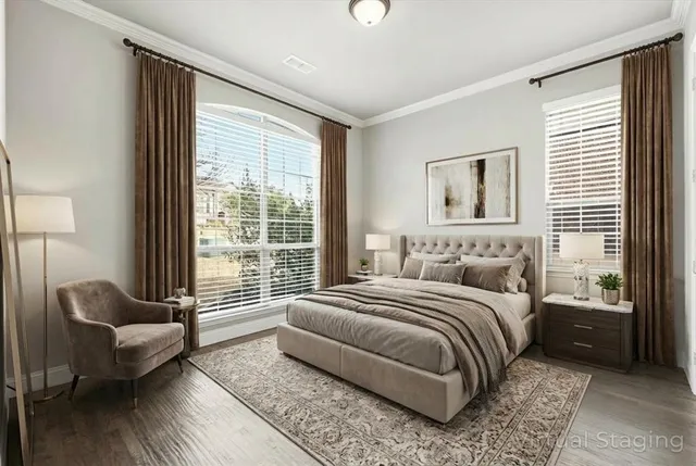 a bedroom with a bed couch and a large window
