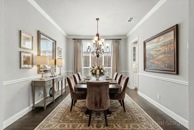 a dining room with furniture a chandelier and wooden floor