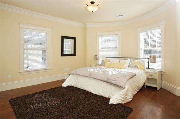 17 Manchester Road Brookline, MA 02446 - Photo 8 of 10 a bedroom with a bed and wooden floor