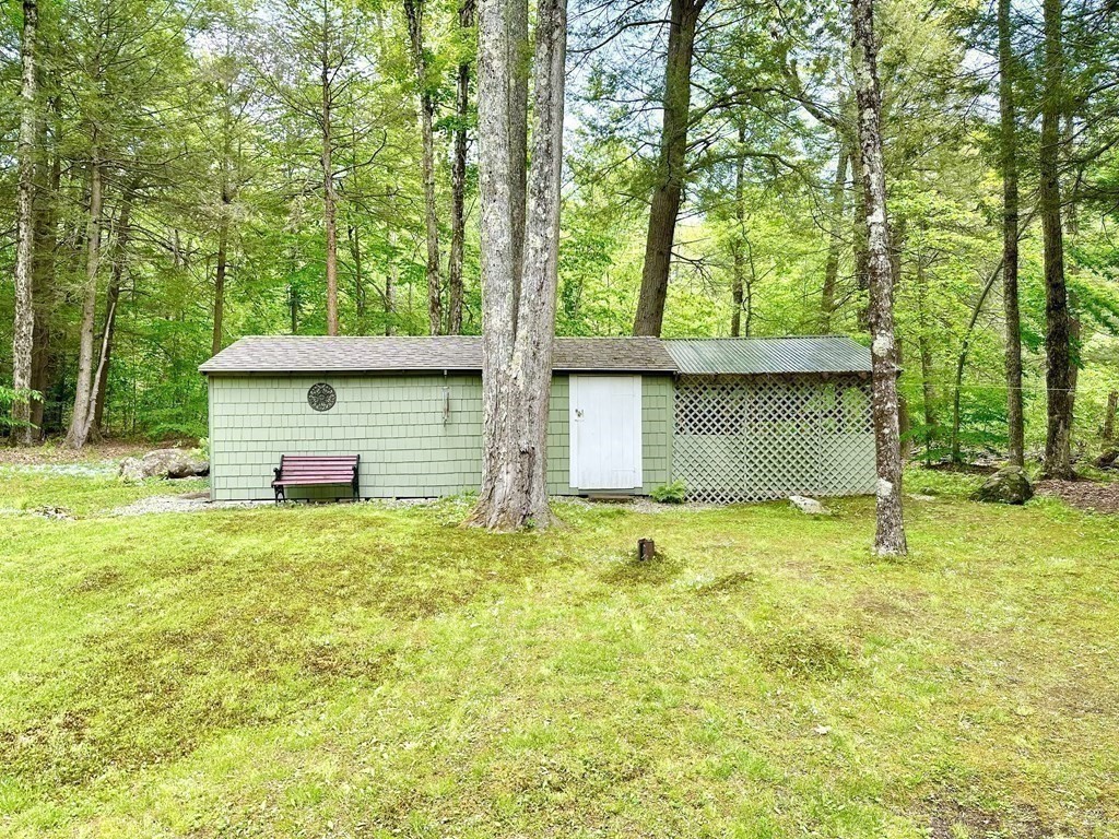 100 Aberdeen Road Goshen, MA 01096 - Photo 23 of 27 a backyard of a house with yard and outdoor seating