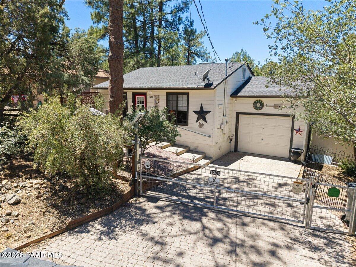 1388 East Pine Ridge Drive Prescott, AZ 86303 - Photo 2 of 16 a front view of a house with a yard