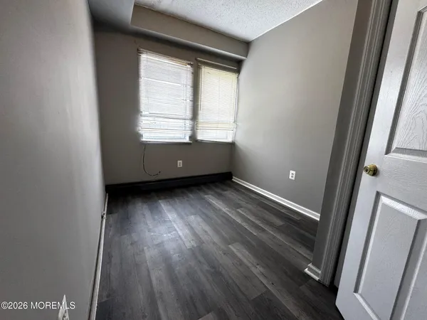 a view of room with window and hardwood floor