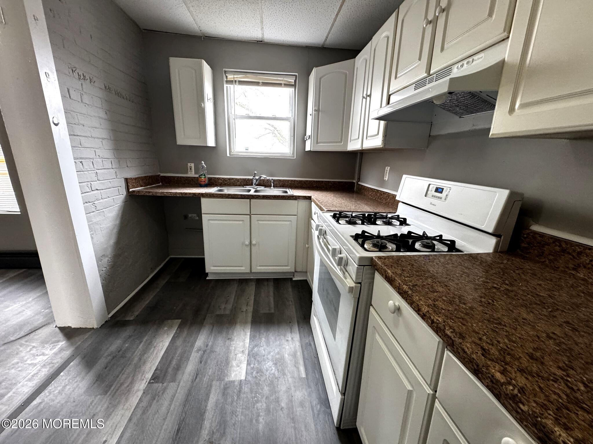 1830 East Riverside Drive Atlantic City, NJ 08401 - Photo 14 of 41 a kitchen with stainless steel appliances granite countertop a stove a sink and a microwave