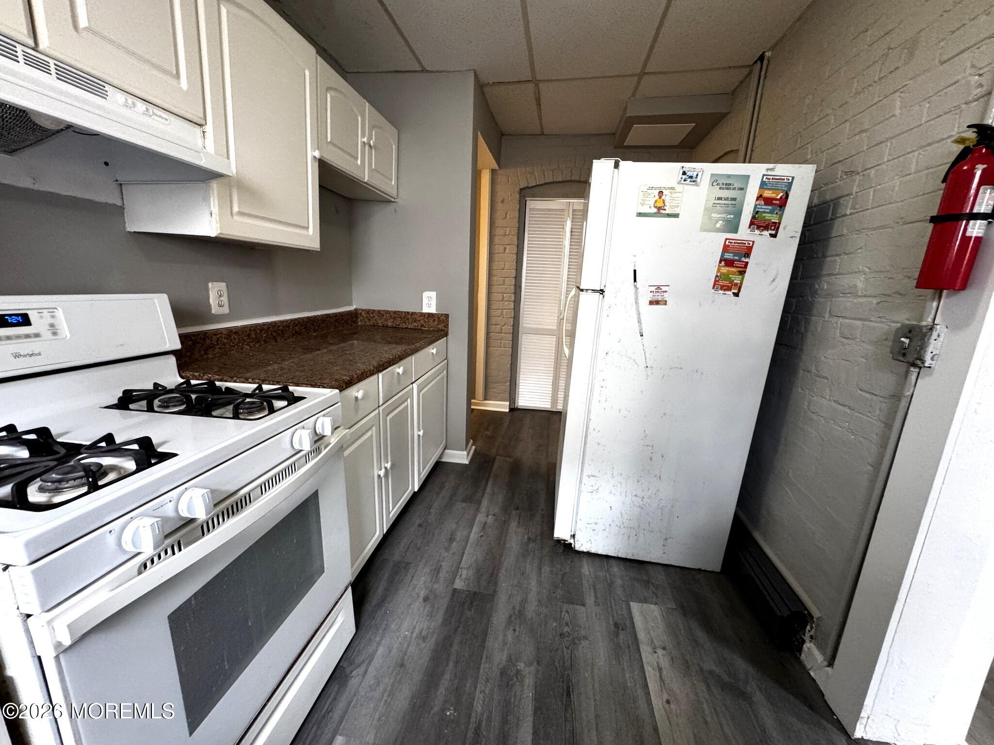 1830 East Riverside Drive Atlantic City, NJ 08401 - Photo 16 of 41 a kitchen with a refrigerator a stove and wooden floor