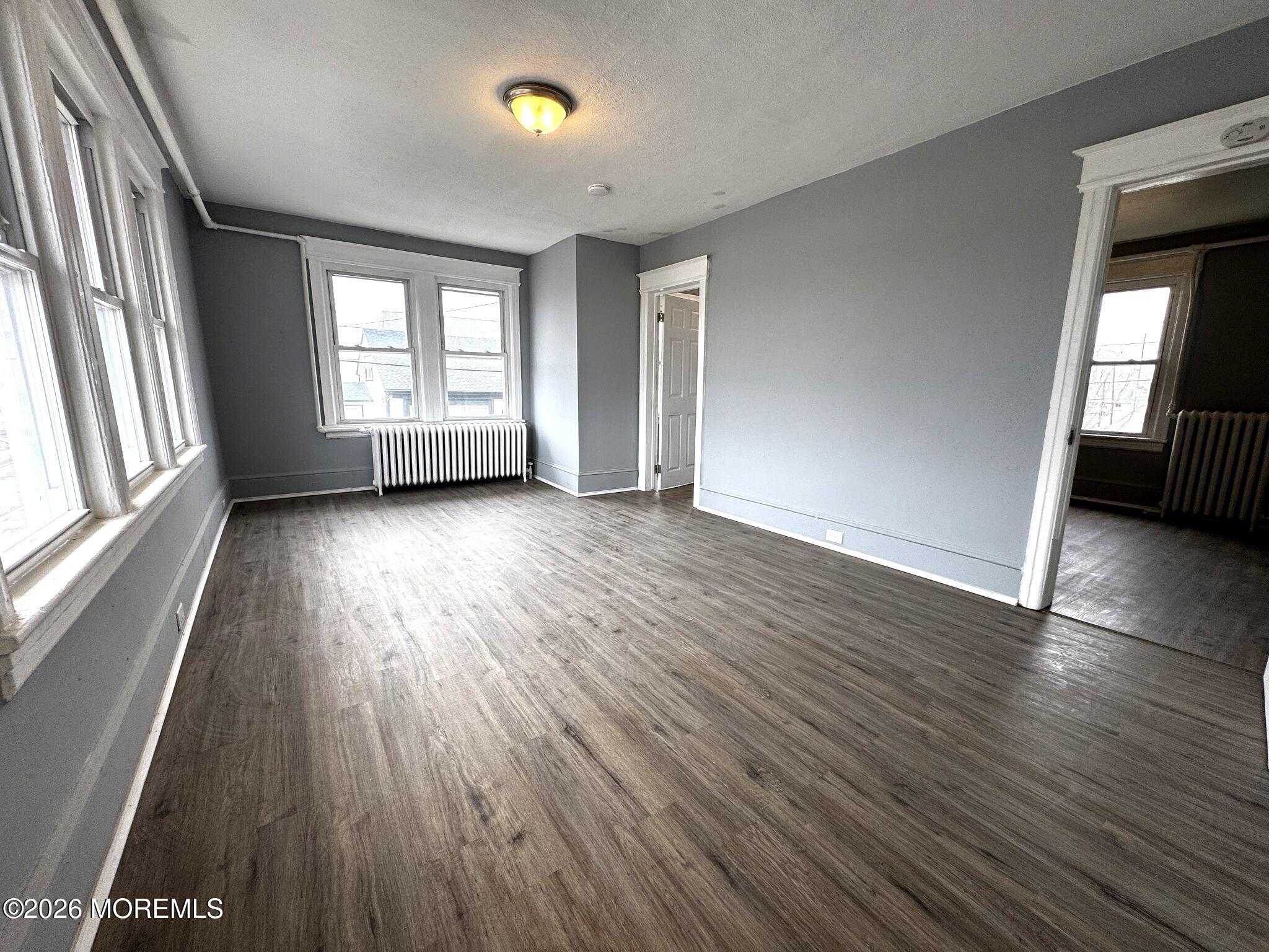 1830 East Riverside Drive Atlantic City, NJ 08401 - Photo 19 of 41 an empty room with wooden floor and windows