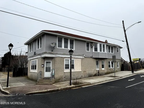 a front view of a house with a street