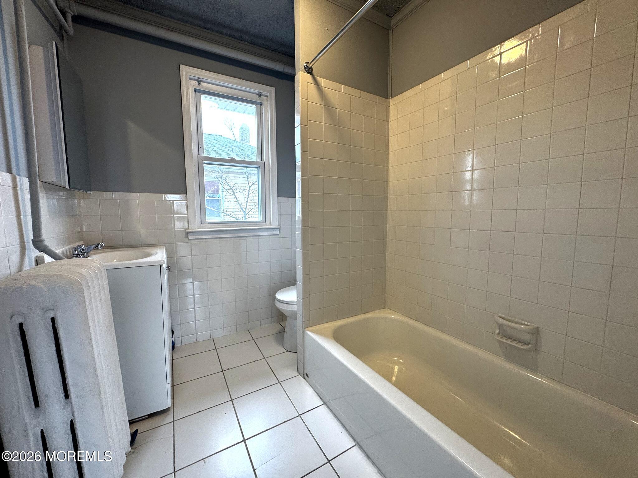 1830 East Riverside Drive Atlantic City, NJ 08401 - Photo 30 of 41 a bathroom with a granite countertop bathtub a toilet and a sink