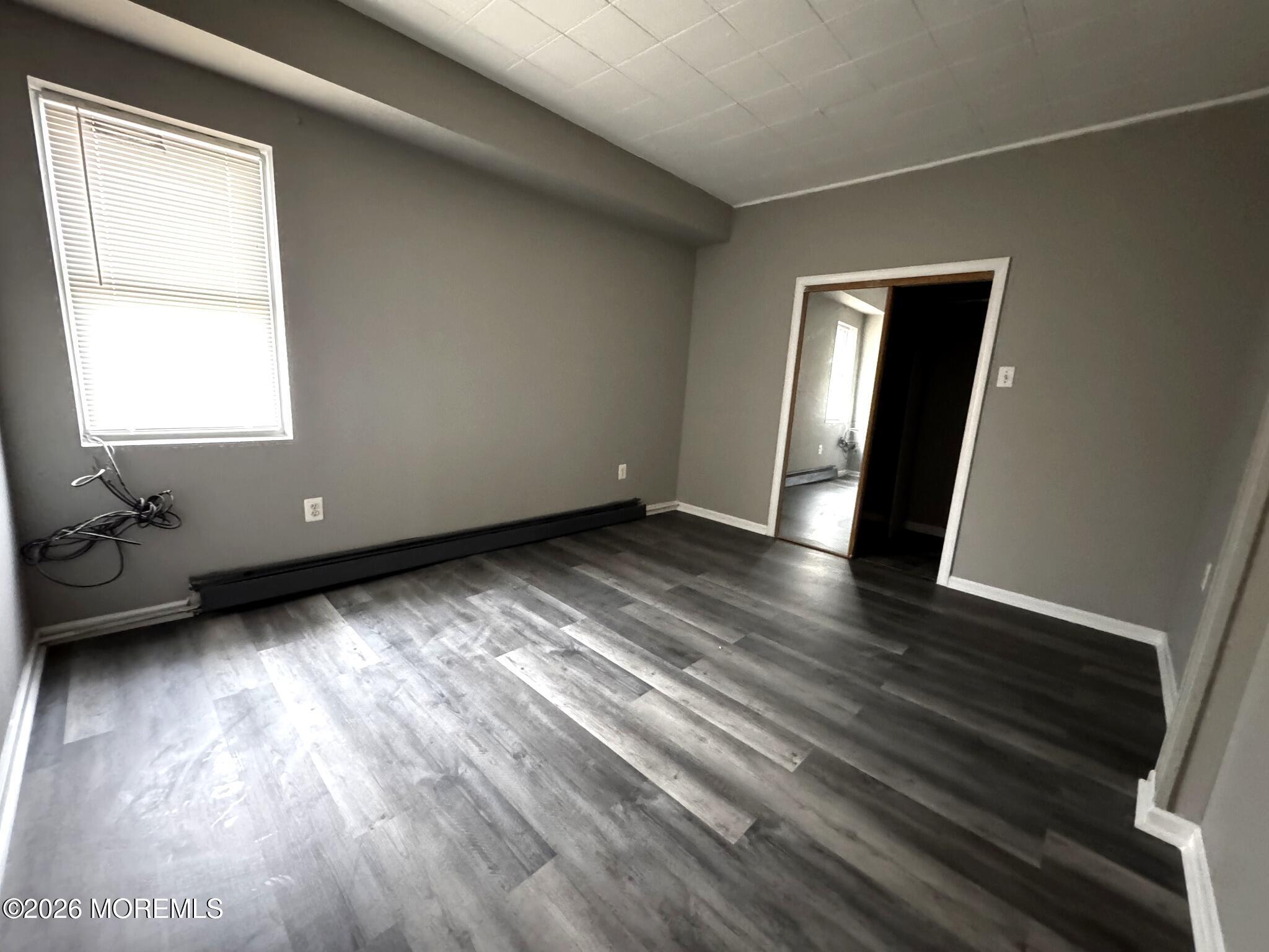 1830 East Riverside Drive Atlantic City, NJ 08401 - Photo 9 of 41 a view of an empty room with wooden floor and a window