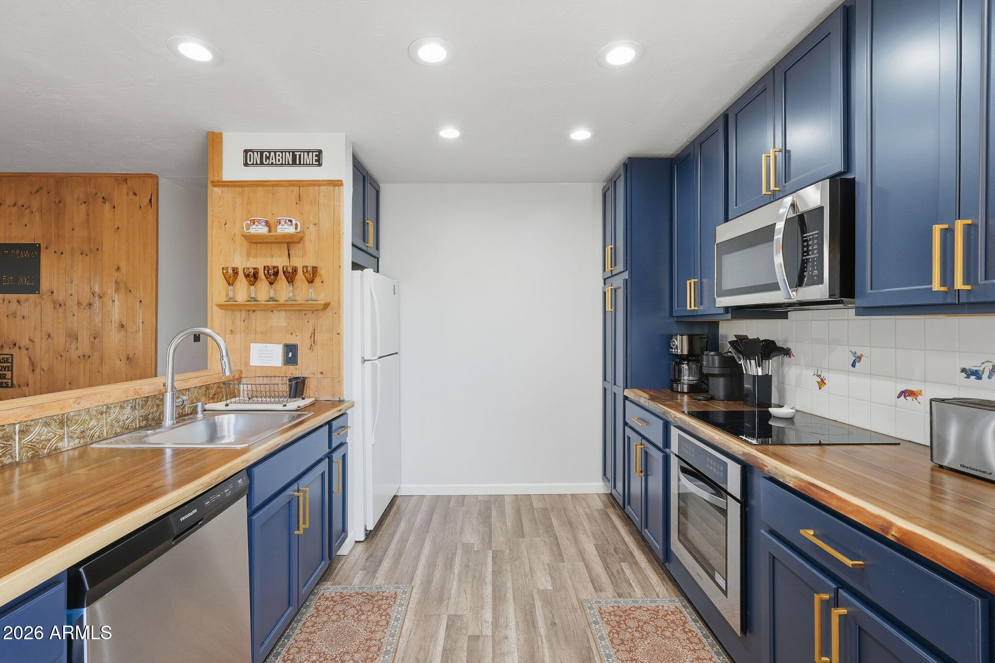8247 Ralls Drive Pine, AZ 85544 - Photo 16 of 50 a kitchen with granite countertop wooden cabinets stainless steel appliances a sink and a window